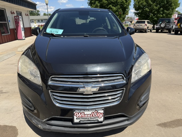 Front view of a black Chevrolet SUV parked in a dealership lot, featuring a chrome grille and Wheel City license plate frame on the bumper.