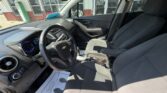 Interior of a Chevrolet car with two front seats, steering wheel, and dashboard visible. (Informative)