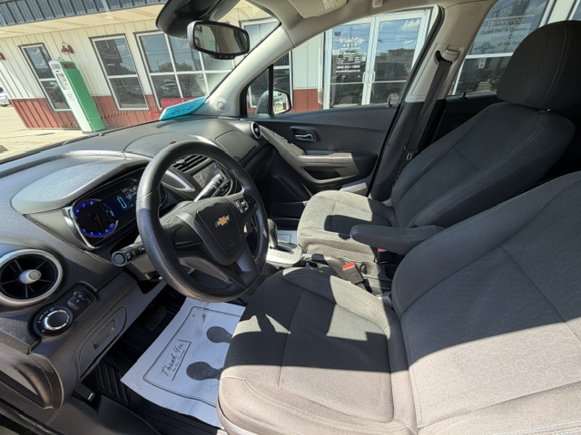 Interior of a Chevrolet car with two front seats, steering wheel, and dashboard visible. (Informative)