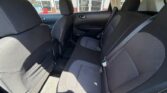 Rear interior of a car showing a three-seat bench with black/gray fabric, headrests, and visible seat belts.
