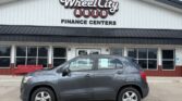 Gray SUV parked in front of Wheel City Auto Finance Centers storefronts sign in the background.