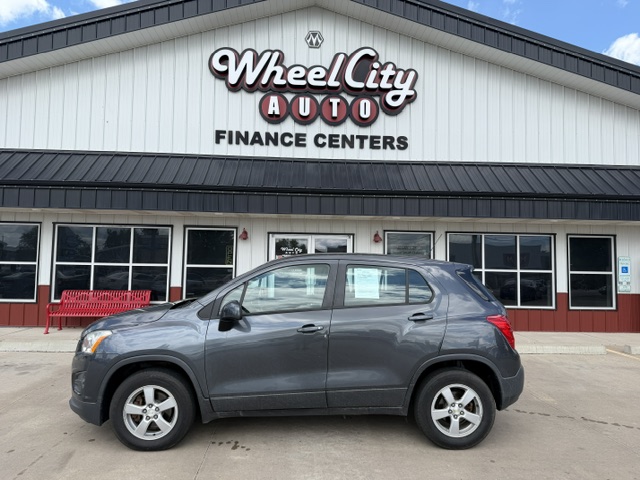 Gray SUV parked in front of Wheel City Auto Finance Centers storefronts sign in the background.