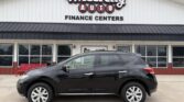 Black crossover SUV parked in front of Wheel City Auto Finance Centers storefront.