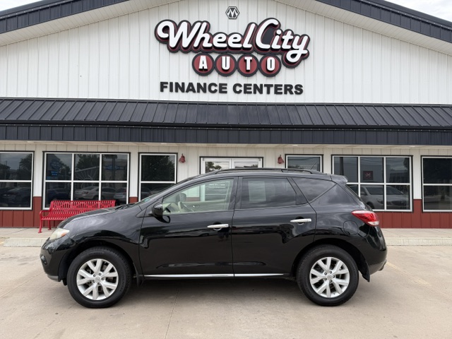Black crossover SUV parked in front of Wheel City Auto Finance Centers storefront.