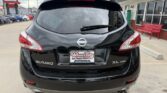 Rear view of a black Nissan Murano SL AWD parked at a dealership, showing taillights, rear wiper, and a Wheel City Auto Finance Centers plate.
