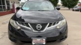 Front view of a black Nissan SUV in a dealership lot, showing the Nissan emblem on the grille and a Wheel City Auto Finance Centers license plate frame.