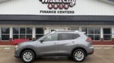 Gray SUV parked in front of Wheel City Auto Finance Centers storefront sign.