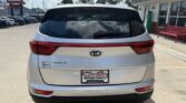Rear view of a silver Kia Sorento SUV in a dealership lot, showing taillights and a Wheel City license plate frame.