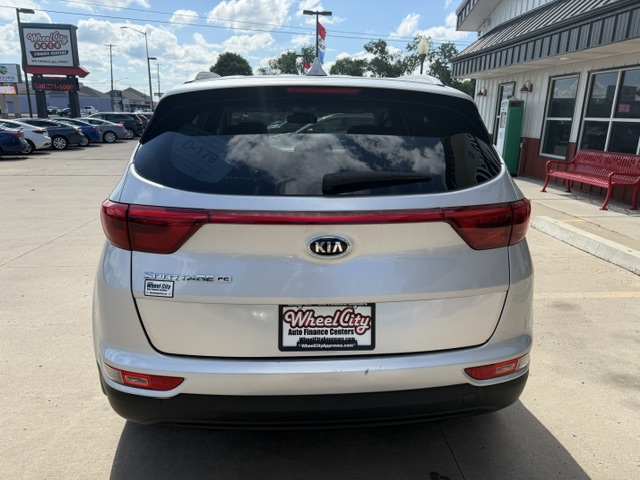 Rear view of a silver Kia Sorento SUV in a dealership lot, showing taillights and a Wheel City license plate frame.