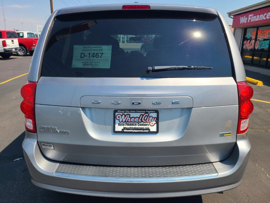 Rear view of a silver Dodge Durango at a car dealership with Wheel City license-plate frame.