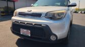 Front view of a silver Kia SUV at a car dealership, Wheel City Auto Finance Centers license plate frame visible on the bumper.