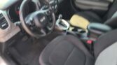 Blurry view of a car interior showing the steering wheel, center console, gear shifter, and front seats.