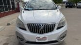 Front view of a white Buick SUV parked in a dealership lot, with a Wheel City license plate frame on the front bumper.