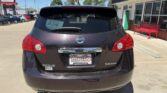 Rear view of a dark gray Nissan Rogue SV AWD parked in a dealership lot, with a Wheel City Auto Finance Centers plate frame visible on the bumper.