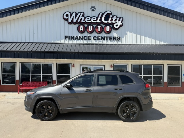 Gray SUV parked in front of Wheel City Auto Finance Centers storefront.