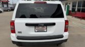 Rear view of a white Jeep SUV in a dealership lot, license plate frame reads Wheel City Auto Finance Centers.