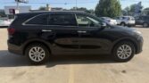 Black mid-size SUV parked in a parking lot, side view with tinted windows and silver door handles.