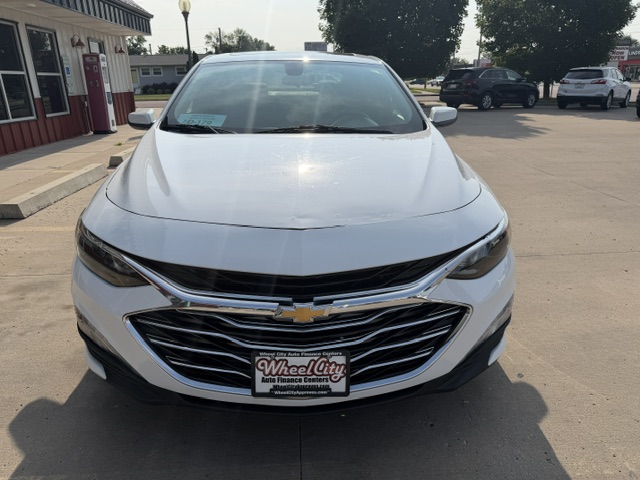 Front view of a white Chevrolet SUV or crossover parked at a dealership lot, showing the chrome grille and Chevrolet emblem with a Wheel City license plate frame.
