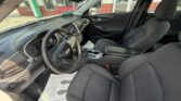 Interior of a Chevrolet with black fabric seats, steering wheel, dashboard, and center console visible from the driver's side.