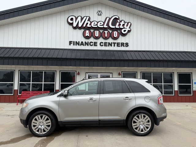 Silver SUV parked in front of Wheel City Auto Finance Centers storefront with large sign above the entrance.