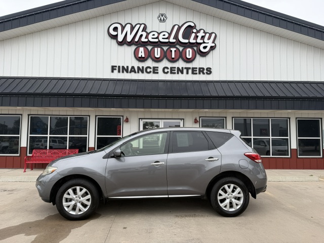 Gray SUV parked in front of Wheel City Auto Finance Centers storefront with large windows and sign above