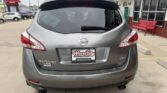 Gray Nissan Murano SUV seen from the rear at a dealership lot; Wheel City license plate frame, AWD badge, visible taillights and rear windshield wiper.