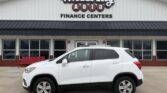 White SUV parked in front of Wheel City Auto Finance Centers storefront.