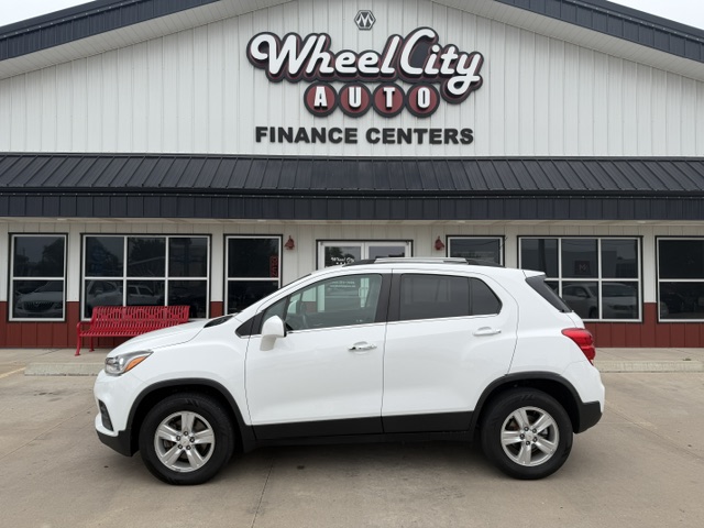 White SUV parked in front of Wheel City Auto Finance Centers storefront.