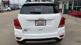 Rear view of a white Chevrolet SUV in a dealership lot, with a Wheel City Auto Finance license plate frame visible.