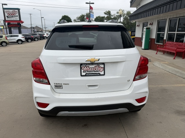 Rear view of a white Chevrolet SUV in a dealership lot, with a Wheel City Auto Finance license plate frame visible.