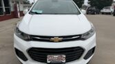 Front view of a white Chevrolet SUV parked in a dealership lot, with the Chevrolet emblem on the grille and a Wheel City Auto Finance Centers license plate frame.