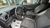 Front interior of a black Chevrolet SUV, showing the driver’s seat, steering wheel, dashboard, and center console.