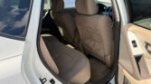 Rear passenger door open, showing the car's beige fabric interior with front seats and back seat cushions visible.
