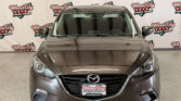 Front view of a gray Mazda SUV in a showroom with a Wheel City Auto Finance Centers backdrop.