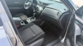 Interior of a dark SUV showing driver’s seat, steering wheel, center console, and dashboard.