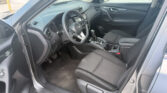 Interior view of a modern car: driver and passenger seats, dashboard, and center console.
