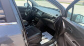 Open driver-side door of a gray Buick SUV, revealing black leather seats and dashboard interior.