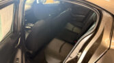 Rear passenger area of a black sedan with the rear door open, showing the back seat and headrests.