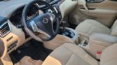 Beige car interior with steering wheel, center console, and front seats visible from the driver’s side