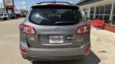 Rear view of a gray Hyundai Santa Fe SUV at a dealership, with a Wheel City license plate frame visible on the bumper.