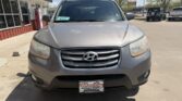 Front view of a gray Hyundai SUV parked in a dealership lot on a sunny day, with a Wheel City license plate frame visible on the front bumper.