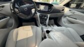 Front interior of a gray SUV showing steering wheel, center console, and touchscreen display above the gear selector.
