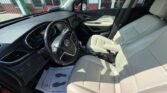 Beige leather front seats and steering wheel visible in a modern car interior.
