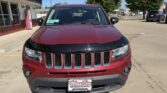 Front view of a red SUV with a black hood guard parked at a car dealership; Wheel City Auto Finance Centers plate frame visible.