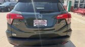 Rear view of a dark gray Honda HR-V AWD parked in a dealership lot, showing the Honda emblem, taillights, and a Wheel City Auto Finance Centers plate frame on the bumper.