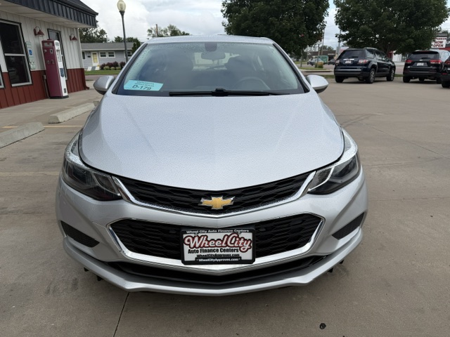 Front view of a silver Chevrolet sedan parked in a dealership lot; visible Wheel City Auto Finance Centers license plate frame on the front bumper.