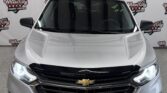 Front view of a silver Chevrolet SUV in a dealership, with Wheel City Auto Finance Centers backdrop.