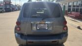 Rear view of a gray Chevrolet Uplander minivan in a dealership lot, with a Wheel City Auto Finance Centers license plate frame.