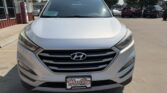 Front view of a white Hyundai SUV on a dealership lot, showing the Hyundai badge and Wheel City license plate frame.