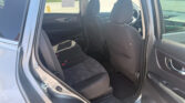 Interior of a dark fabric SUV, open rear door, showing the backseat and two front seats (driver and passenger). It’s daytime outside.